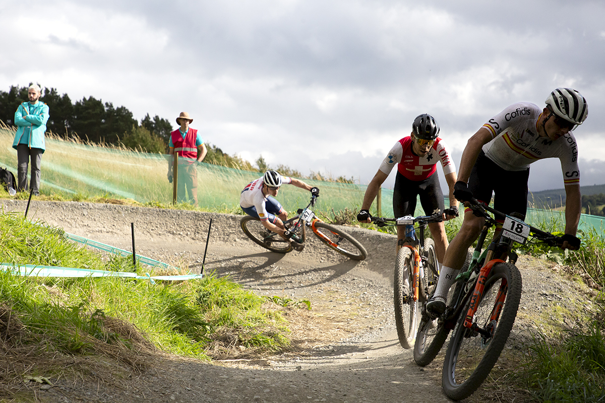 2023 UCI Cycling World Championships - Mountain Bike - Elite Men - Riders from Spain, Switzerland and Great Britain corner on a berm