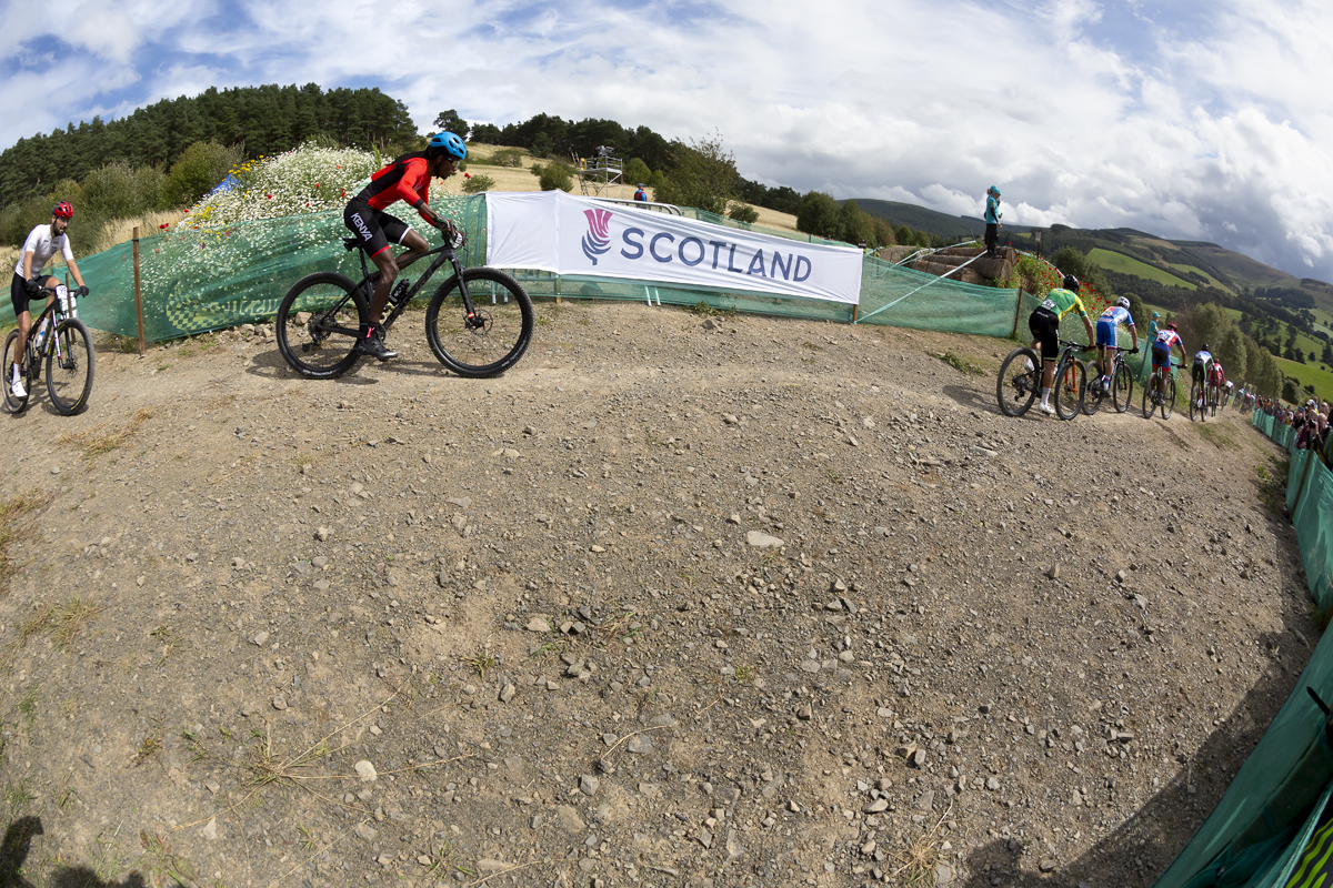 2023 UCI Cycling World Championships - Mountain Bike - Elite Men - The riders pass a Scotland banner at the start of the race