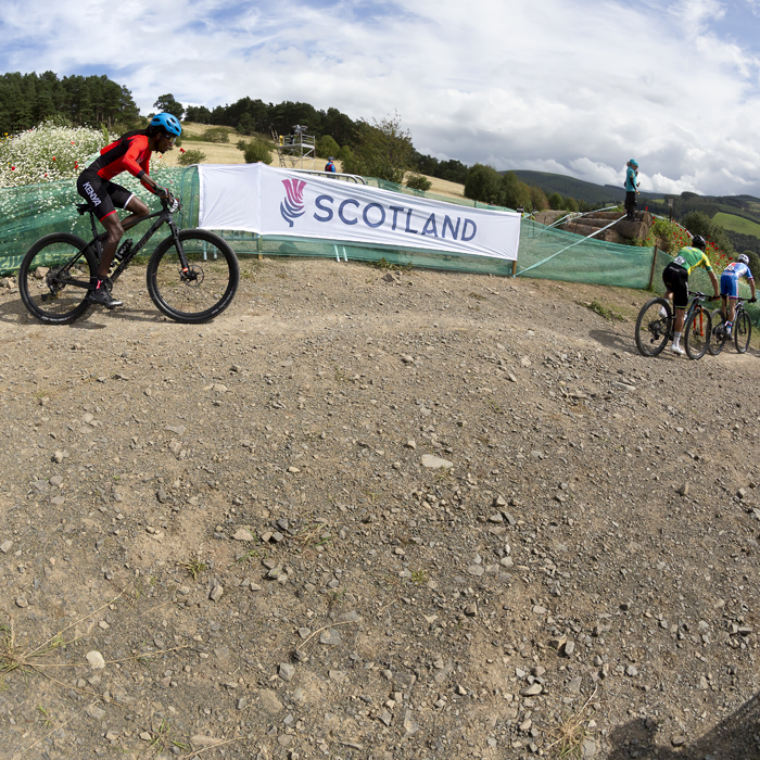 2023 UCI Cycling World Championships - Mountain Bike - Elite Men - The riders pass a Scotland banner at the start of the race