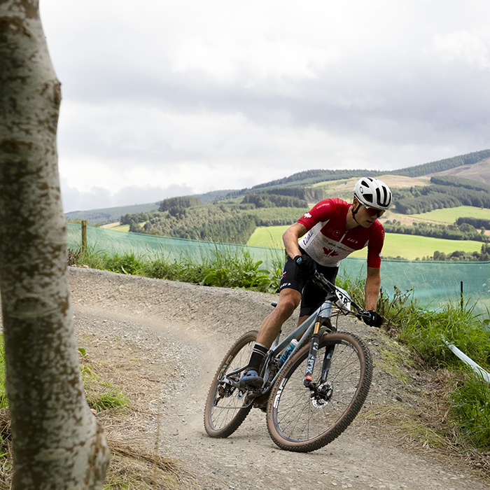 2023 UCI Cycling World Championships - Mountain Bike - Elite Men - Gunnar Holmgren of Canada exits the berm with the Scottish Borders behind