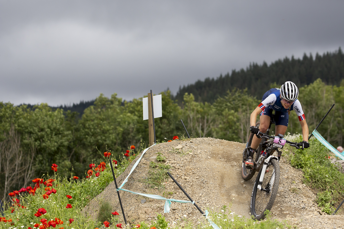 2023 UCI Cycling World Championships - Mountain Bike - Elite Women - Loana Lecomte of France rides down a bank covered in wild flowers