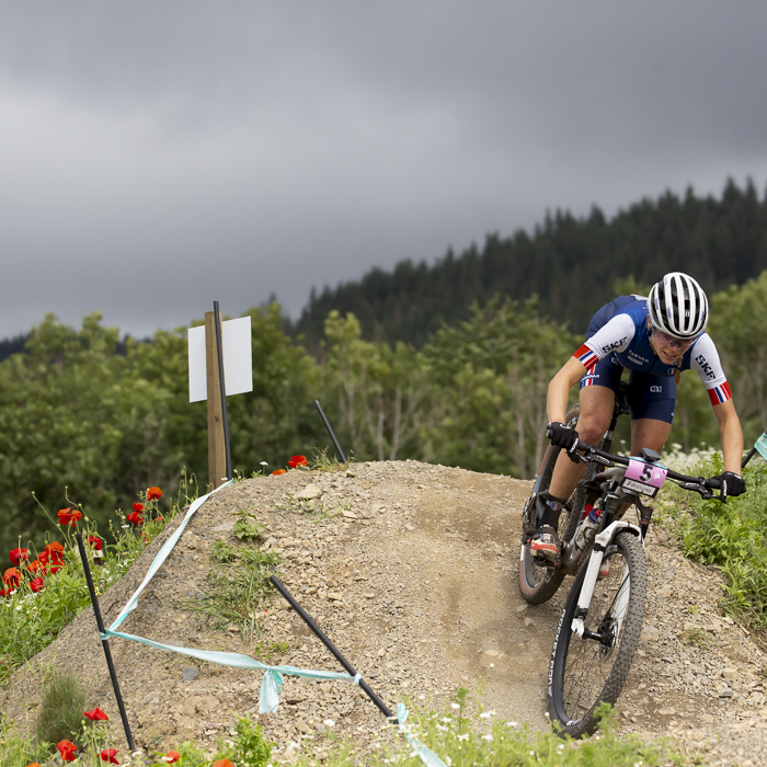 2023 UCI Cycling World Championships - Mountain Bike - Elite Women - Loana Lecomte of France rides down a bank covered in wild flowers