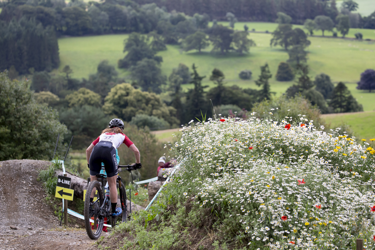 2023 UCI Cycling World Championships - Mountain Bike - Elite Women - Sandra Walter of Canada passes a bank of wild flowers