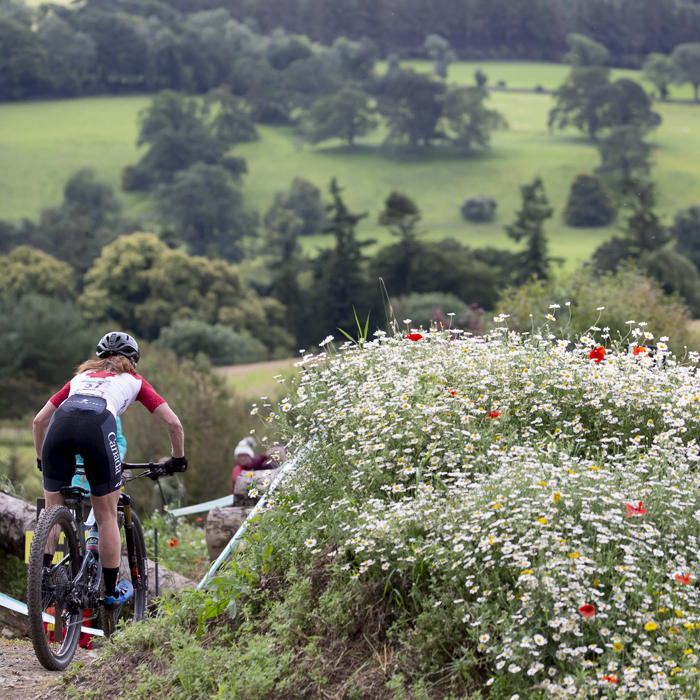 2023 UCI Cycling World Championships - Mountain Bike - Elite Women - Sandra Walter of Canada passes a bank of wild flowers