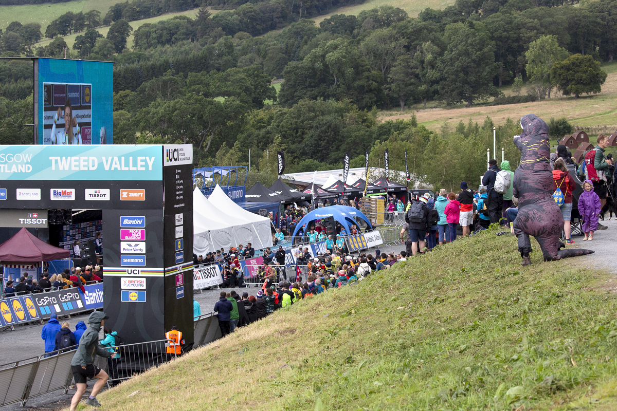 2023 UCI Cycling World Championships - Mountain Bike - Elite Women - A fan dressed in a purple dinosaur costume takes in the race