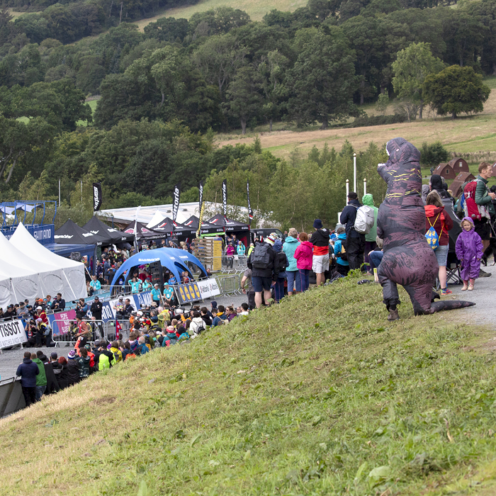 2023 UCI Cycling World Championships - Mountain Bike - Elite Women - A fan dressed in a purple dinosaur costume takes in the race