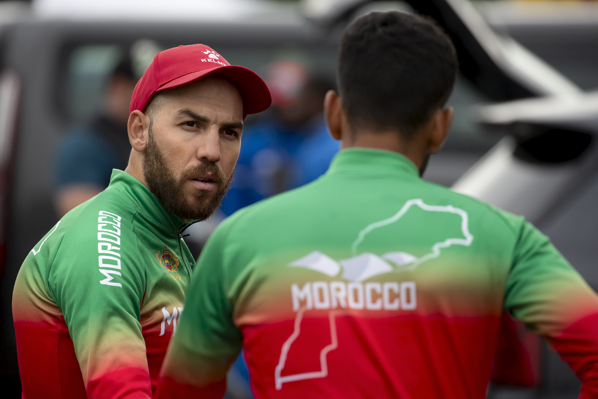 2023 UCI Cycling World Championships - Road Race - Elite Men - Adil El Arbaoui of Morocco talks to a team mate before the race begins