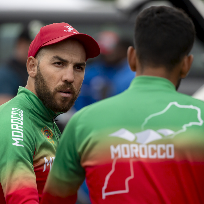2023 UCI Cycling World Championships - Road Race - Elite Men - Adil El Arbaoui of Morocco talks to a team mate before the race begins
