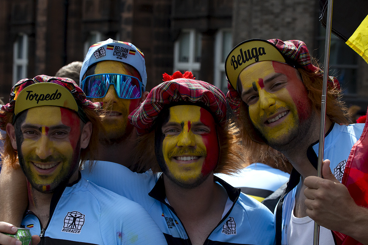 2023 UCI Cycling World Championships - Road Race - Elite Men - Belgian fans with their faces painted in their national flag wear tartan hats as they pose for the camera