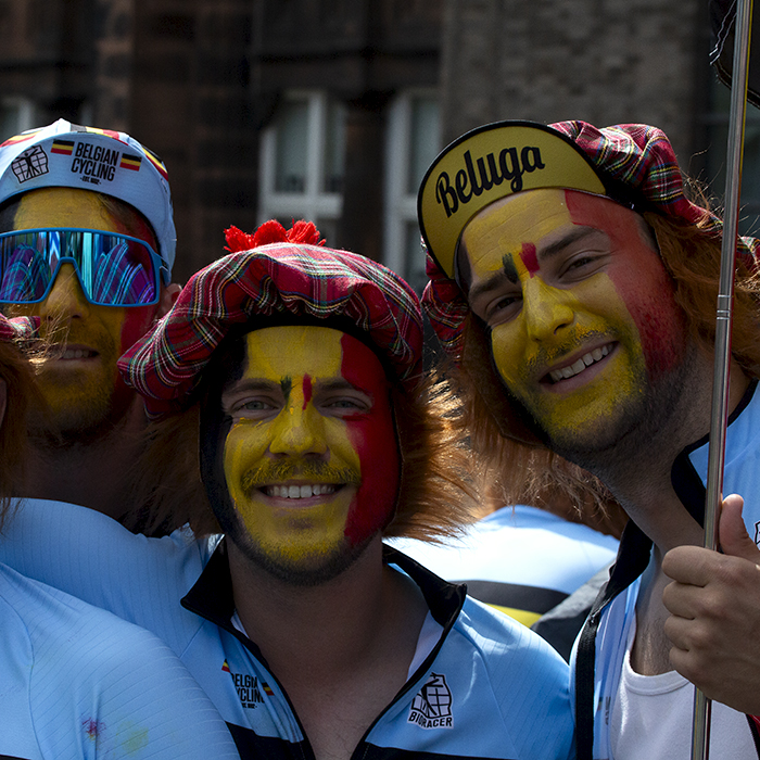 2023 UCI Cycling World Championships - Road Race - Elite Men - Belgian fans with their faces painted in their national flag wear tartan hats as they pose for the camera