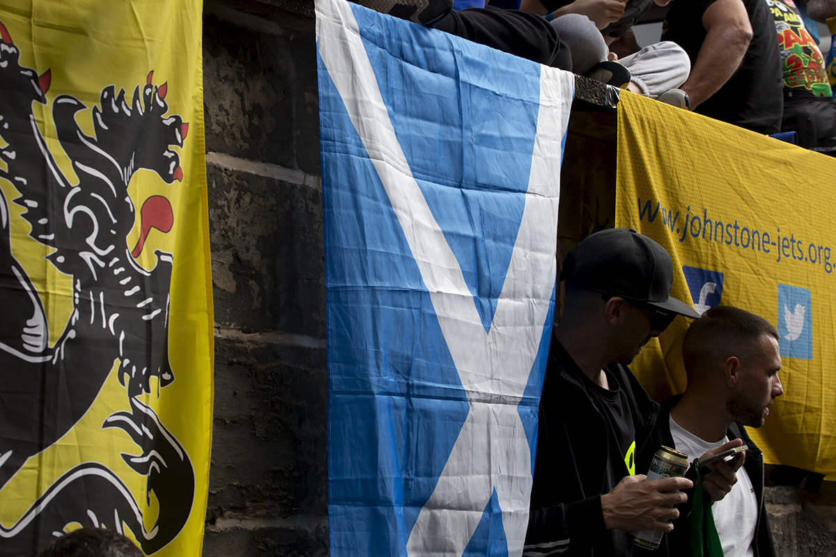 2023 UCI Cycling World Championships - Road Race - Elite Men - Fans stand next to a Saltire flag as they wait for the race