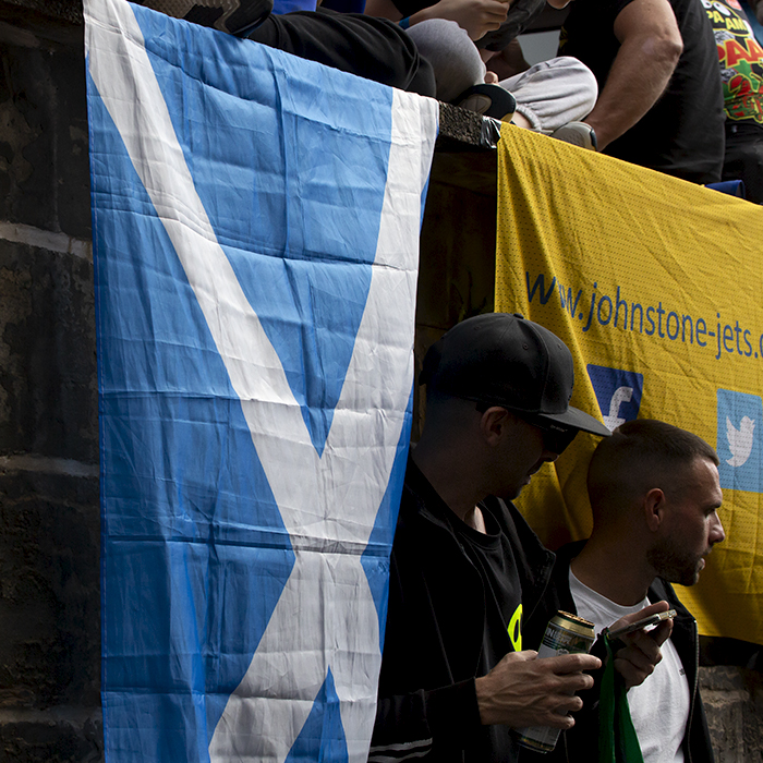 2023 UCI Cycling World Championships - Road Race - Elite Men - Fans stand next to a Saltire flag as they wait for the race