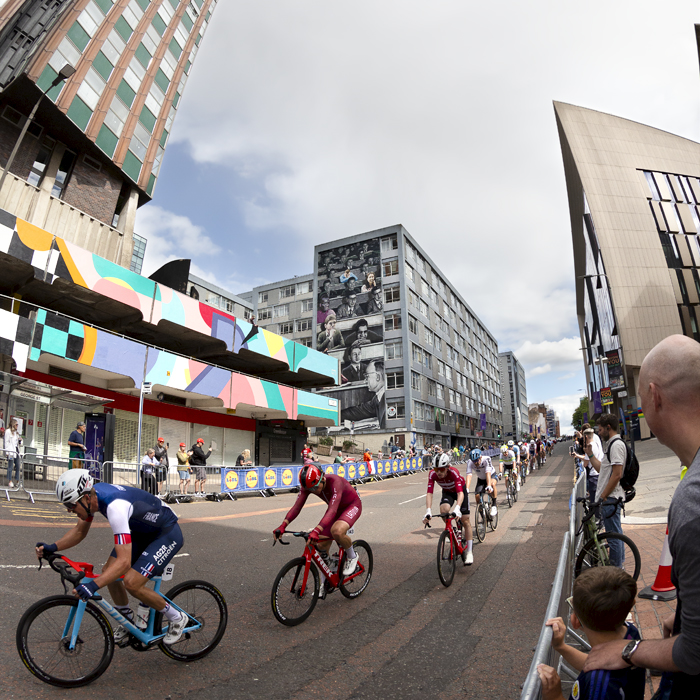 2023 UCI Cycling World Championships - Road Race - Elite Men - The race passes by the Livingstone Tower with one of the Glasgow murals in the background