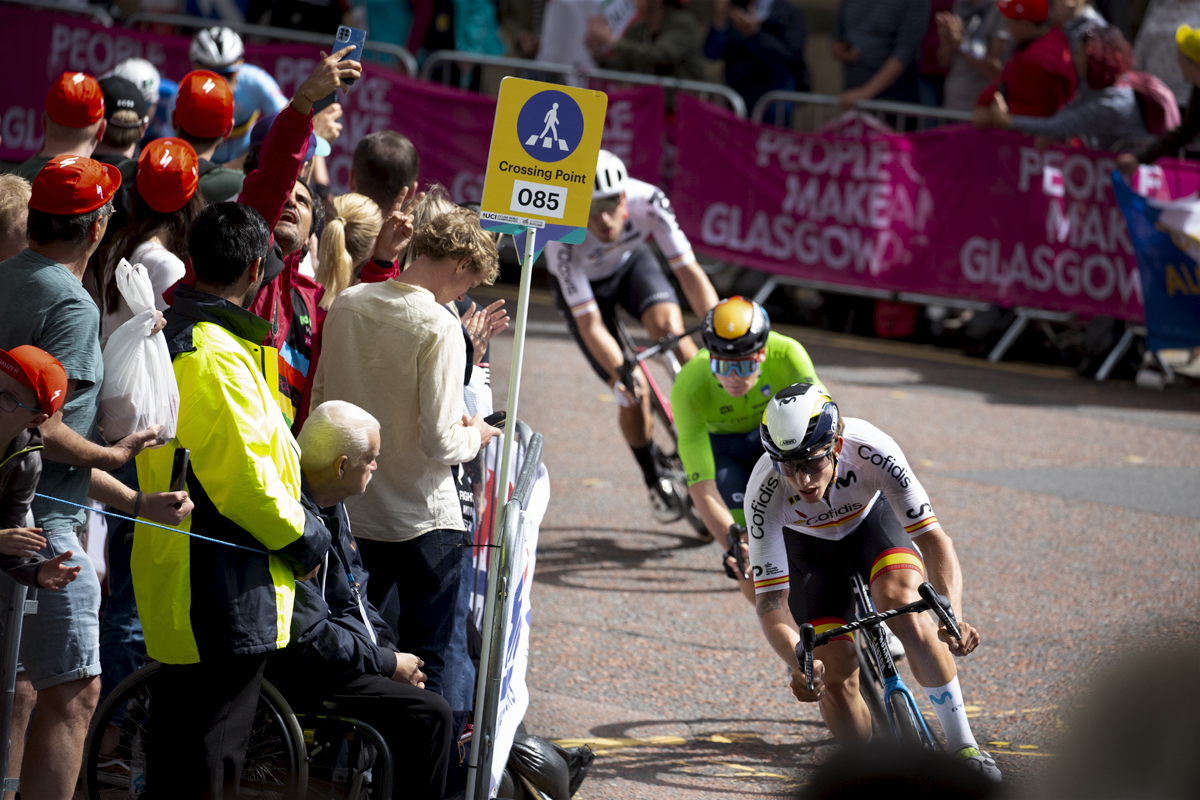 2023 UCI Cycling World Championships - Road Race - Elite Men - Spain’s Iván García Cortina leads a group round the corner as fans watch on