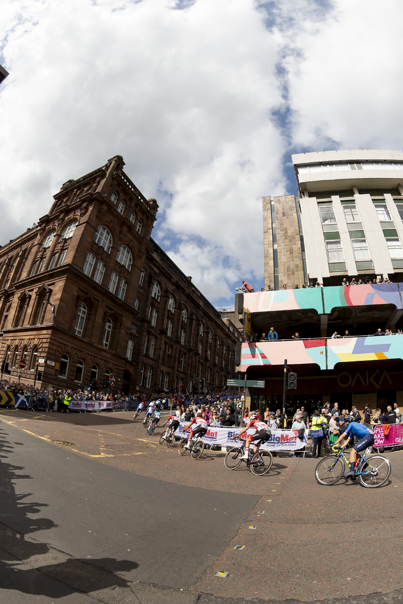 2023 UCI Cycling World Championships - Road Race - Elite Men - The race rounds the corner from George Street past the Royal College Building as fans watch on from their vantage points