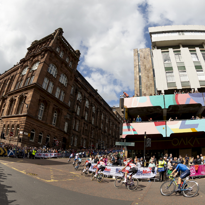 2023 UCI Cycling World Championships - Road Race - Elite Men - The race rounds the corner from George Street past the Royal College Building as fans watch on from their vantage points