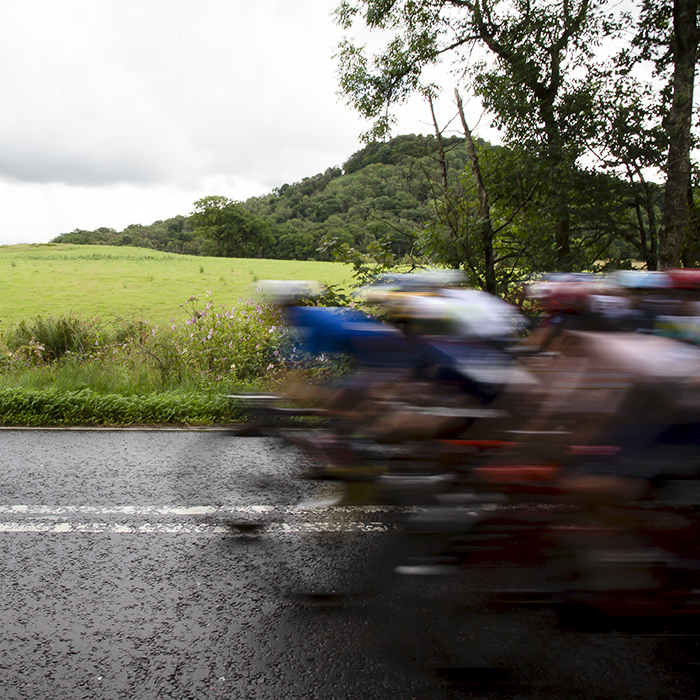 2023 UCI Cycling World Championships - Road Race - Elite Women - The peloton speed into shot with the countryside behind them