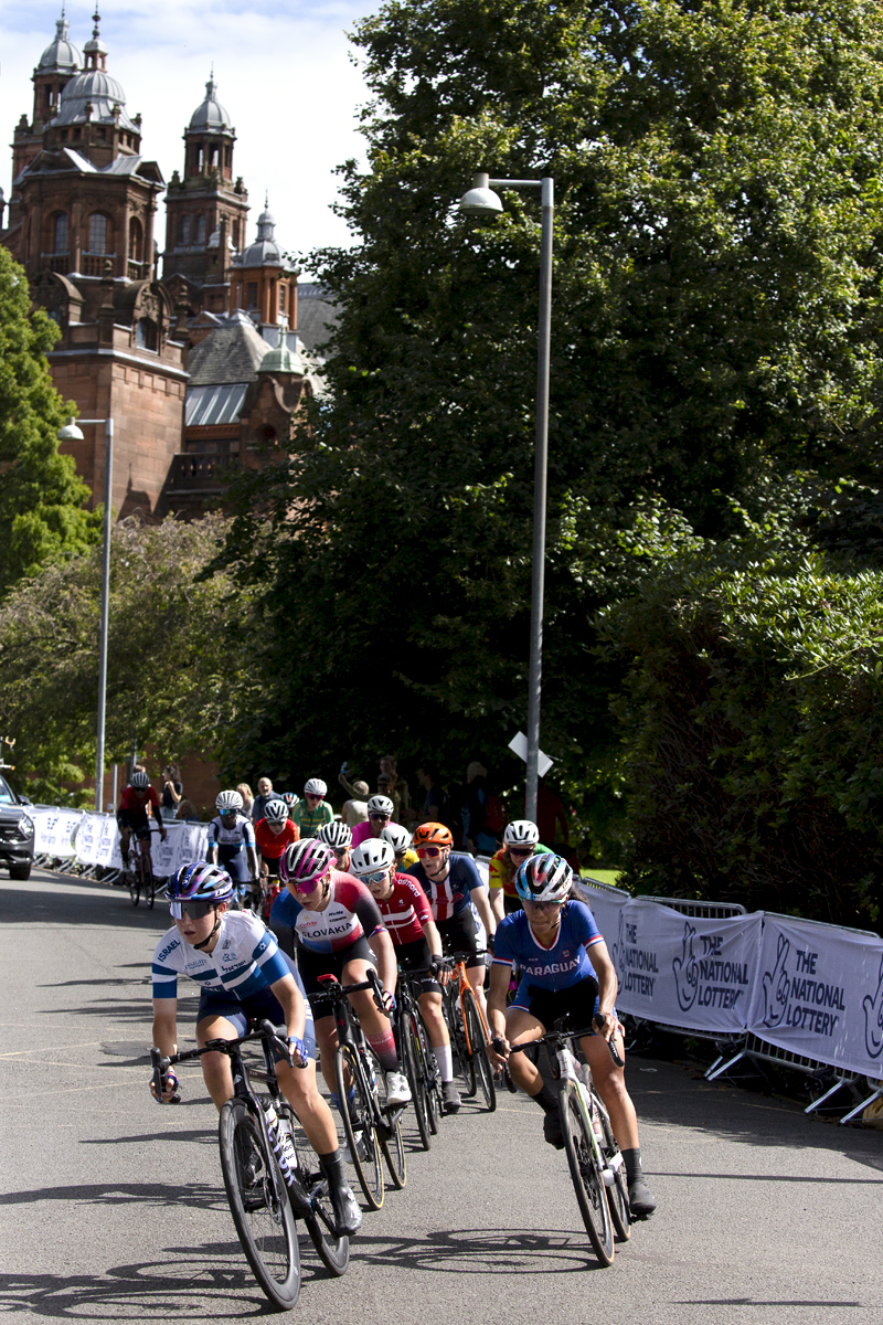 2023 UCI Cycling World Championships - Road Race - Elite Women - A group of riders pass Kelvingrove Art Gallery and Museum