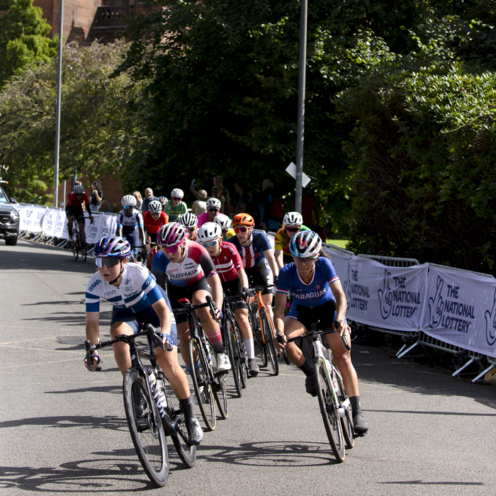 2023 UCI Cycling World Championships - Road Race - Elite Women - A group of riders pass Kelvingrove Art Gallery and Museum