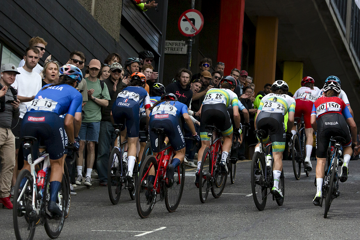 2023 UCI Cycling World Championships - Road Race - Elite Women - A group of riders make their way past fans lining Scott Street