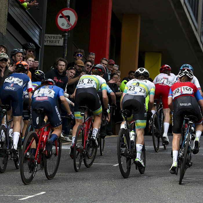 2023 UCI Cycling World Championships - Road Race - Elite Women - A group of riders make their way past fans lining Scott Street