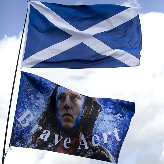 2023 UCI Cycling World Championships - Time Trial - Elite Men - A Saltire and a flag with Wout van Aert depicted as a Scottish warrior and the caption Brave Aert