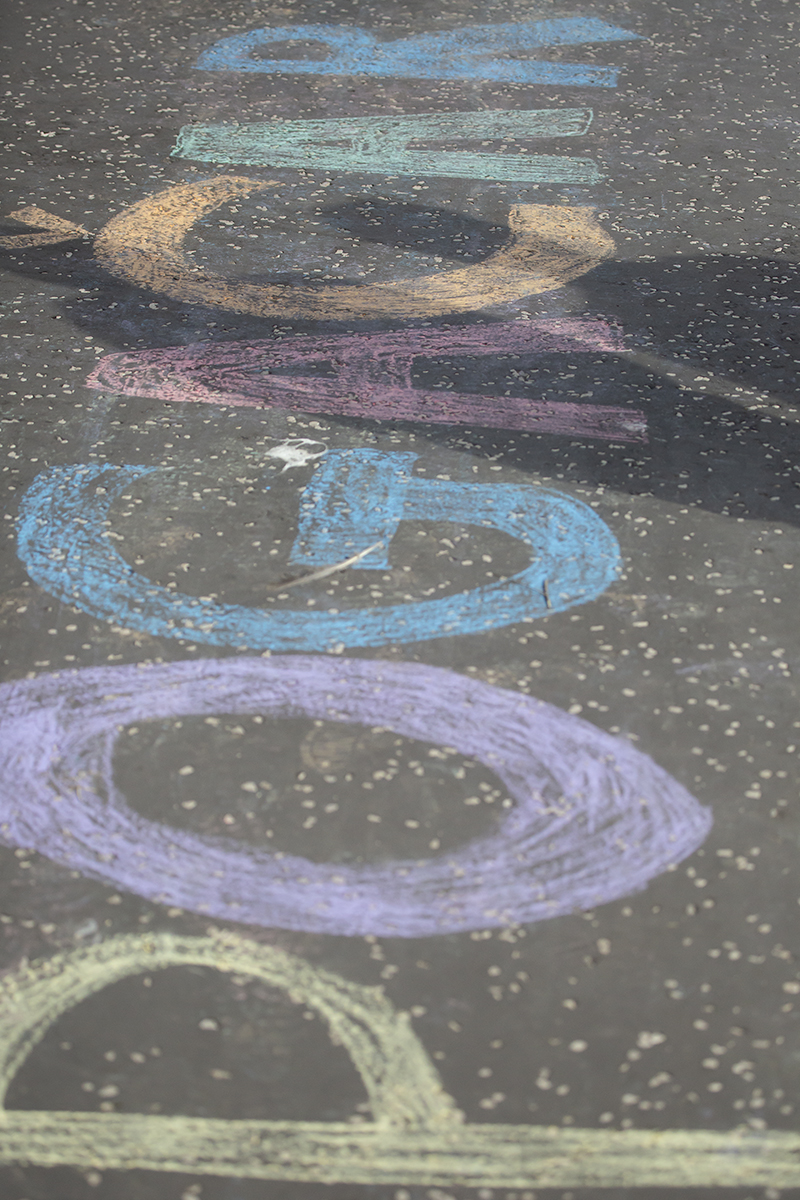 2023 UCI Cycling World Championships - Time Trial - Elite Men - Pogačar written on the pavement in different coloured chalk