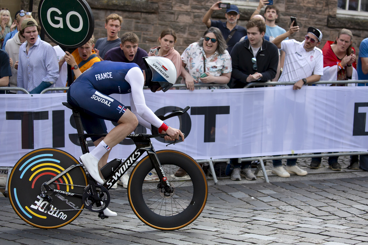 2023 UCI Cycling World Championships - Time Trial - Elite Men - France’s Remi Cavagna passes in front of a raucous crowd holding a large go sign