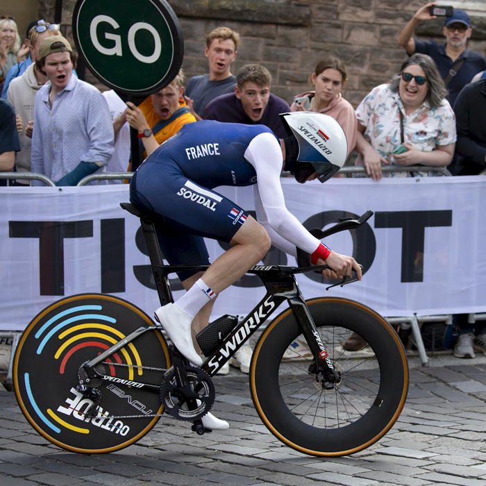 2023 UCI Cycling World Championships - Time Trial - Elite Men - France’s Remi Cavagna passes in front of a raucous crowd holding a large go sign