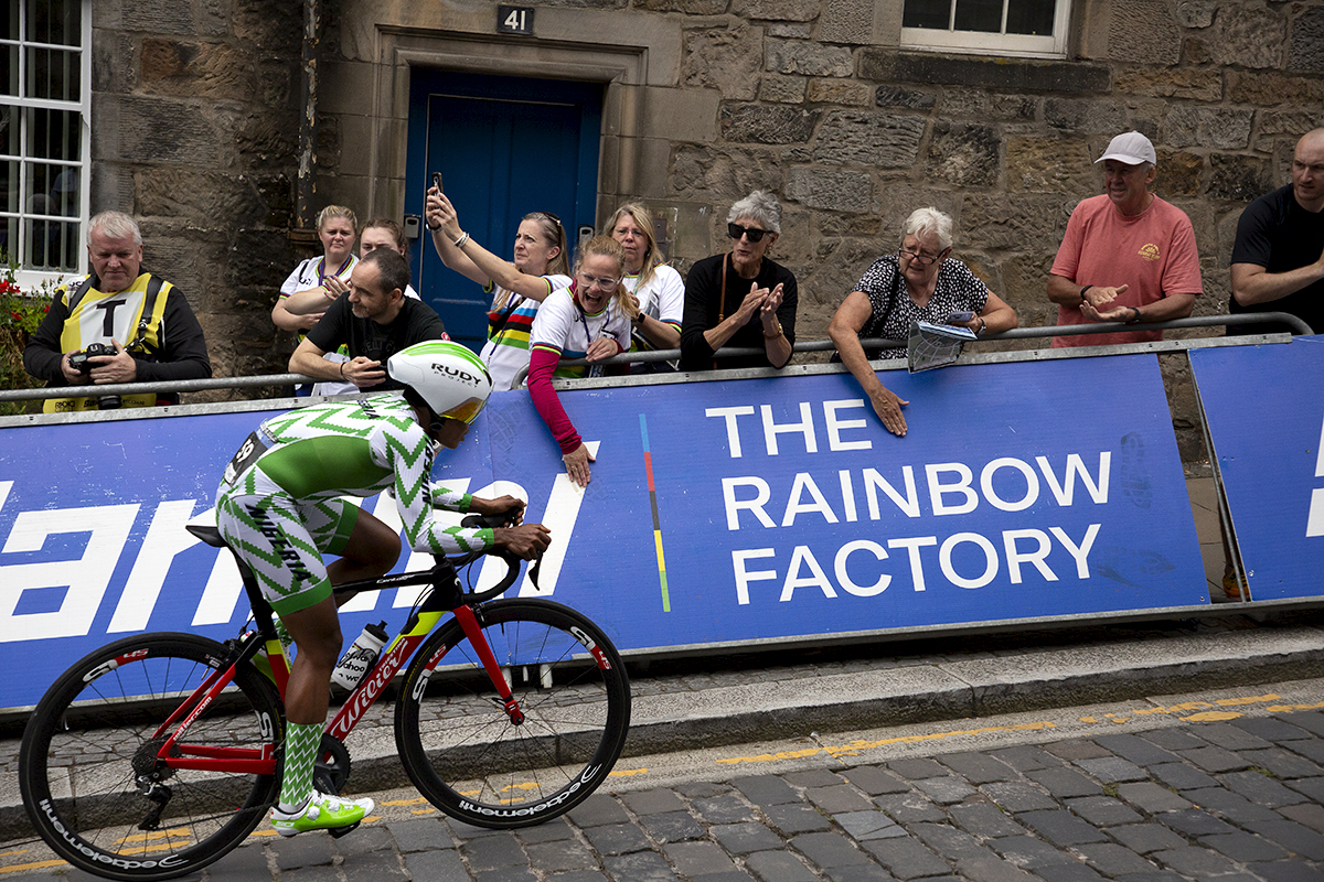 2023 UCI Cycling World Championships - Time Trial - Elite Women - Mary Samuel of Nigeria passes fans applauding and banging on the hoardings as she climbs the cobbles towards the finish