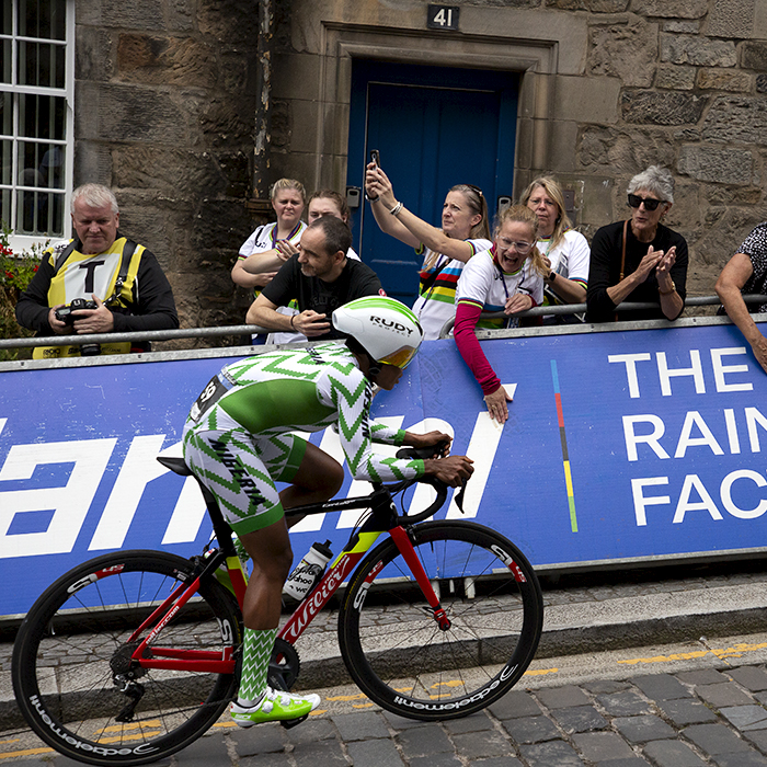 2023 UCI Cycling World Championships - Time Trial - Elite Women - Mary Samuel of Nigeria passes fans applauding and banging on the hoardings as she climbs the cobbles towards the finish