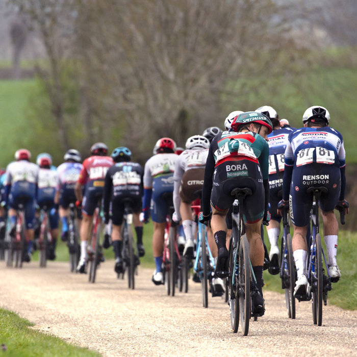 Amstel Gold Race 2023 - The peloton from the rear with an old couple watching them pass