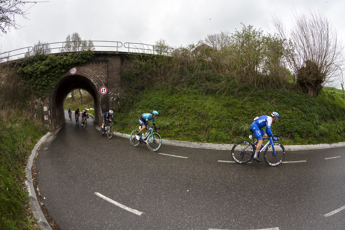 Amstel Gold Race 2023 - Riders pass under a railway bridge in Schoonbron