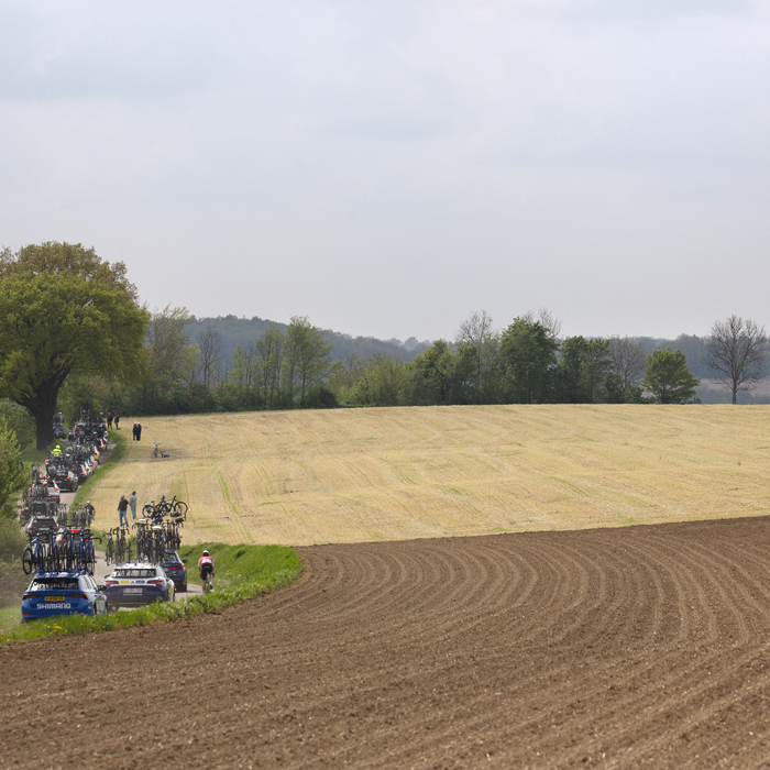 Amstel Gold Race 2024 - Team cars follow the race with one rider seen moving through the convoy on Heugdenweg