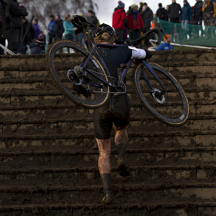 British National Cyclo-Cross Championships 2023 - Annie Last carries her bike on her shoulder up the steps