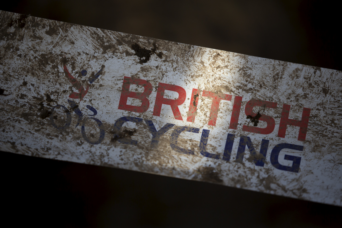 British National Cyclo-Cross Championships 2023 - British Cycling Logo covered in mud on tape surrounding the course