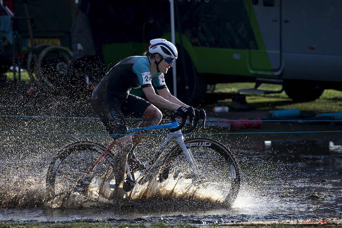 British National Cyclo-Cross Championships 2023 - Water splashes up as Ceris Styler rides on the course