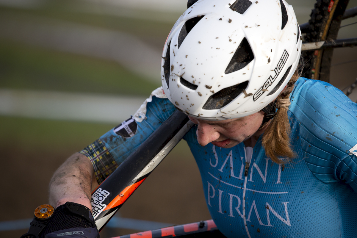 British National Cyclo-Cross Championships 2023 - Christina Wiejak carries her bike on her shoulder with her head down