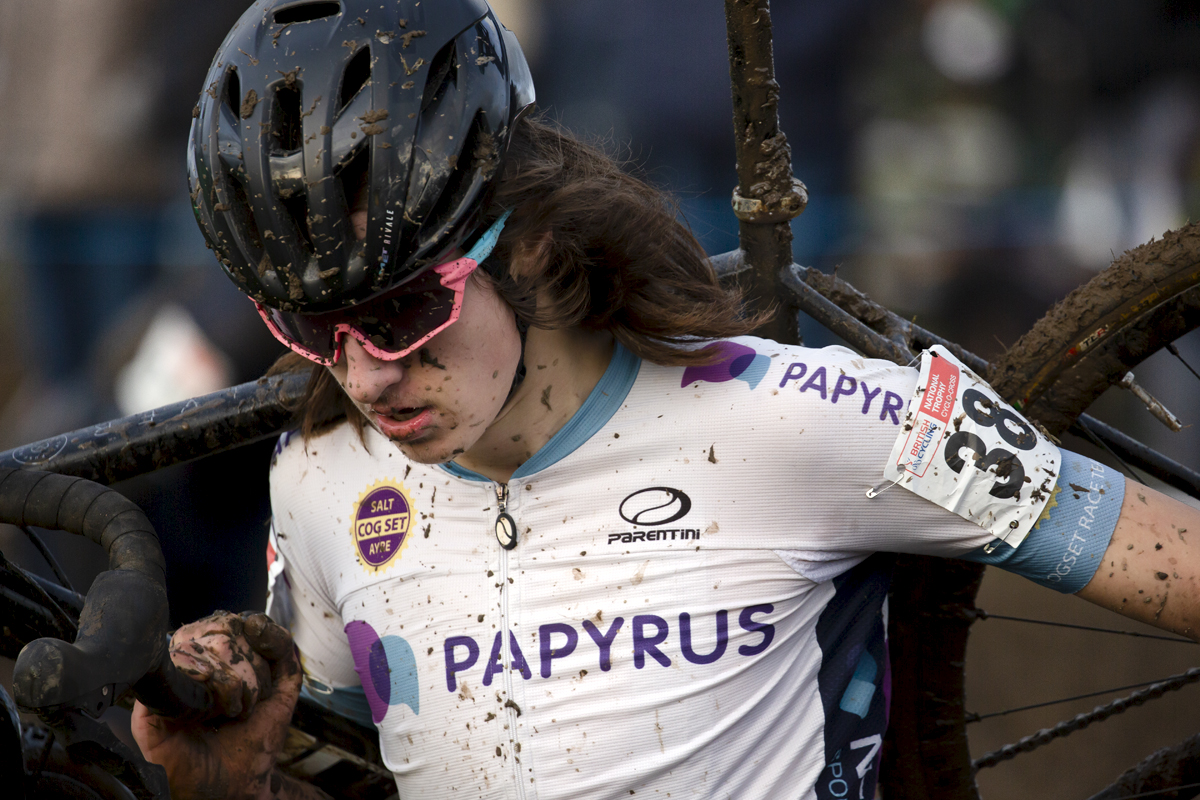 British National Cyclo-Cross Championships 2023 - Jake Edwards carries his bike on his shoulder through a muddy section