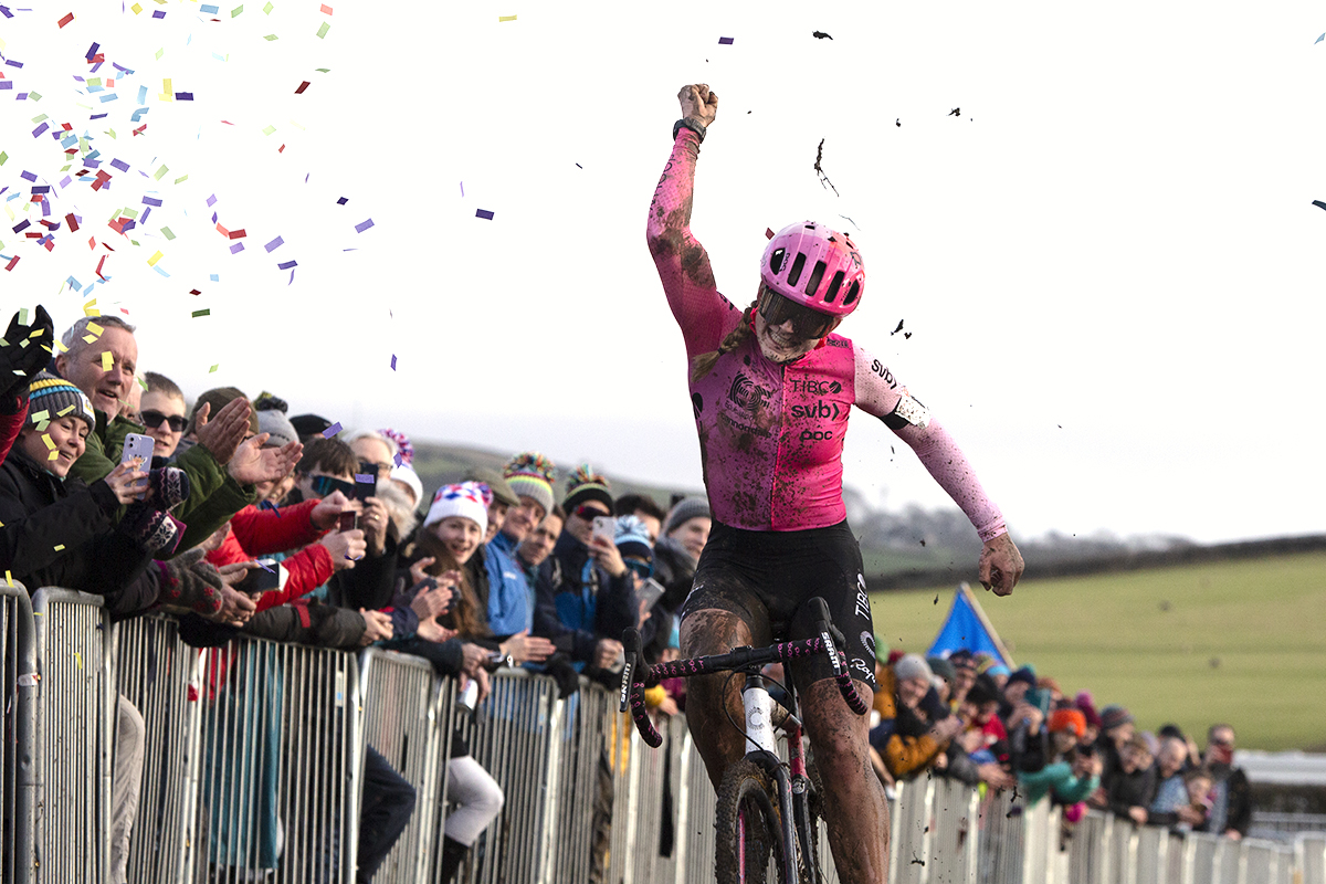 British National Cyclo-Cross Championships 2023 - Zoe Bäckstedt throws her arm up in victory as confetti rains down