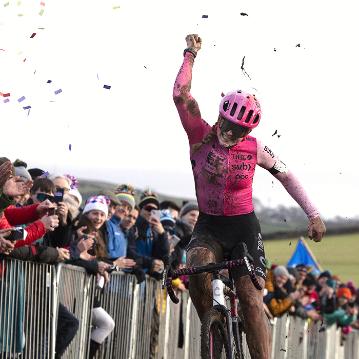 British National Cyclo-Cross Championships 2023 - Zoe Bäckstedt throws her arm up in victory as confetti rains down