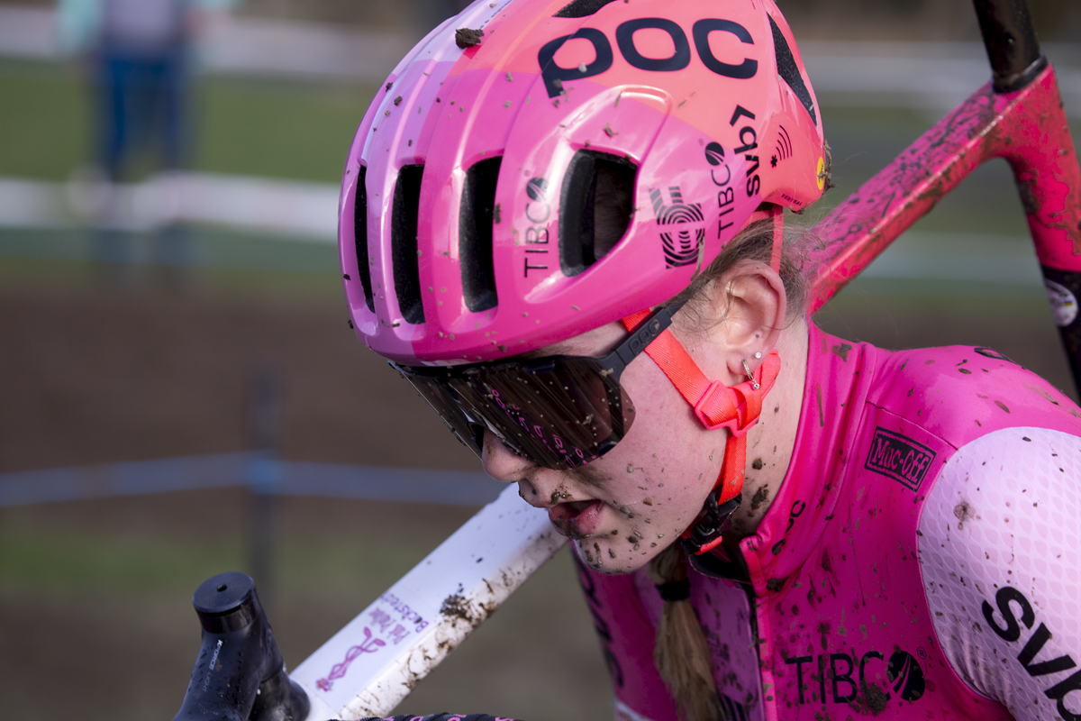 British National Cyclo-Cross Championships 2023 - Close up of Zoe Bäckstedt and she carries her bike through a muddy section