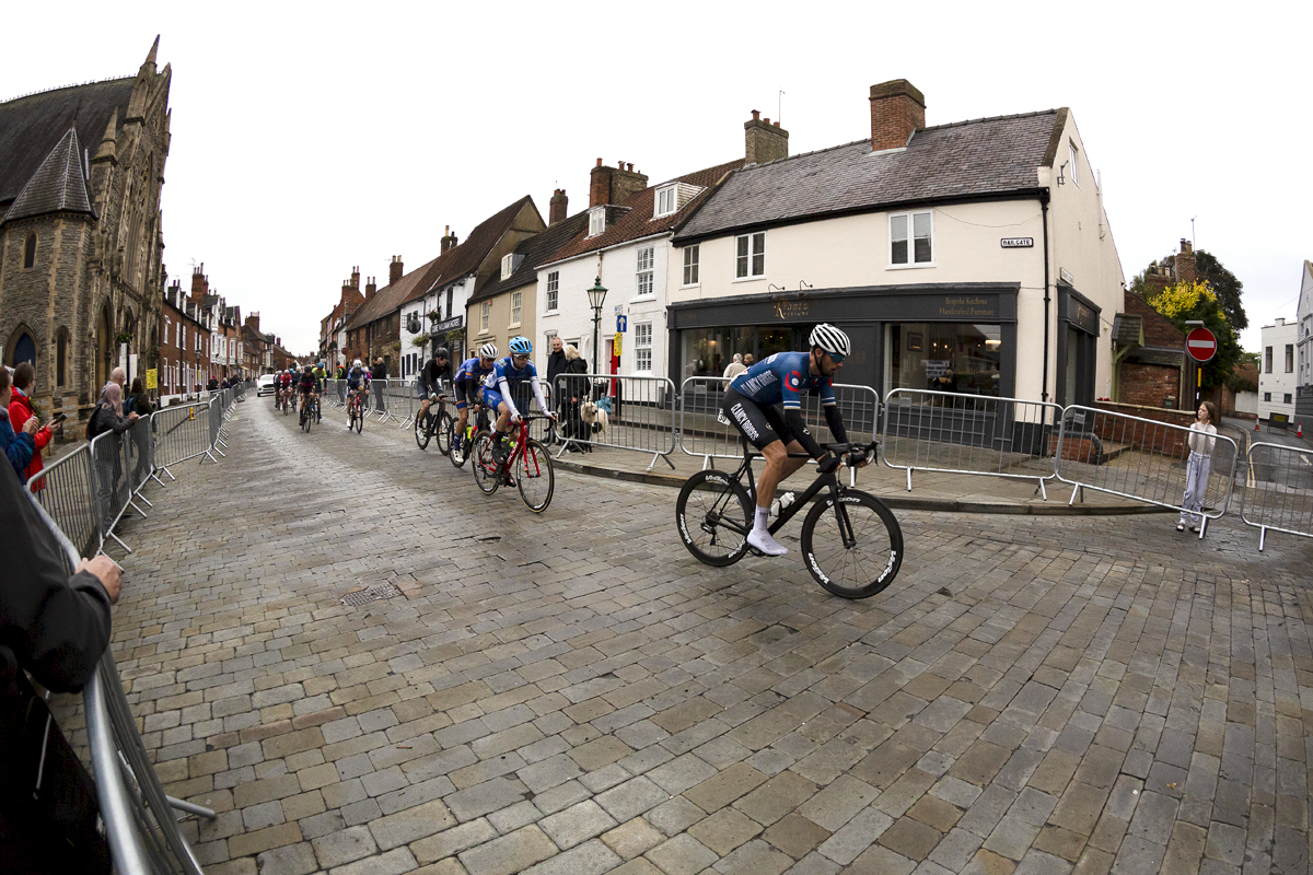 British National Road Championships 2021 - Men’s Road Race - Riders pass a row of shops