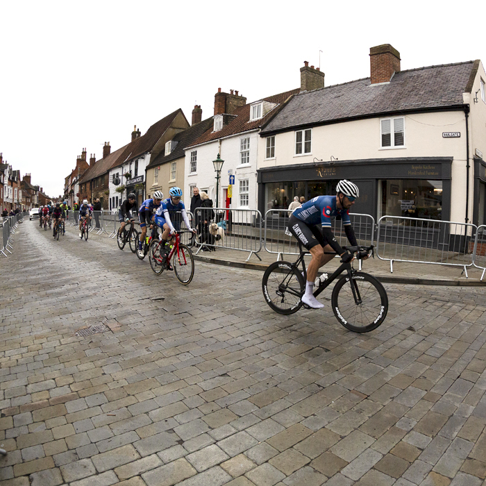 British National Road Championships 2021 - Men’s Road Race - Riders pass a row of shops