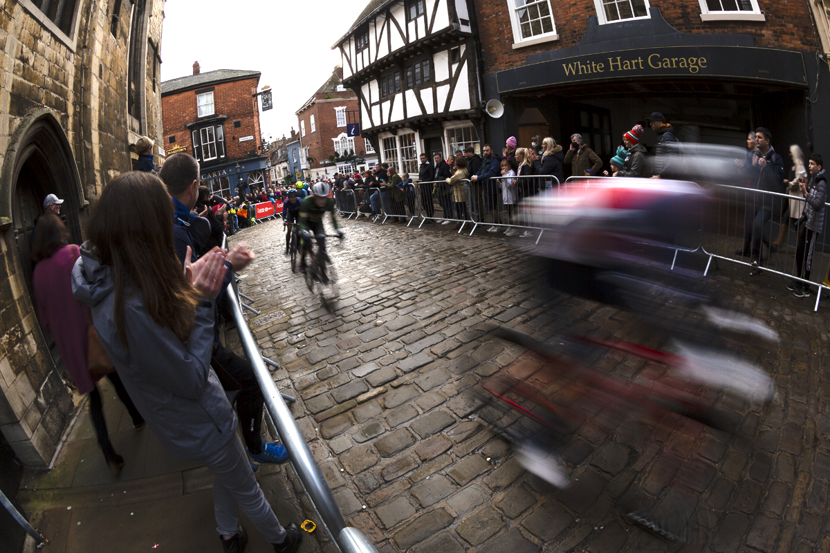 British National Road Championships 2021 - Men’s Road Race - Riders speed past in a blur as fans line Bailgate near medieval buildings