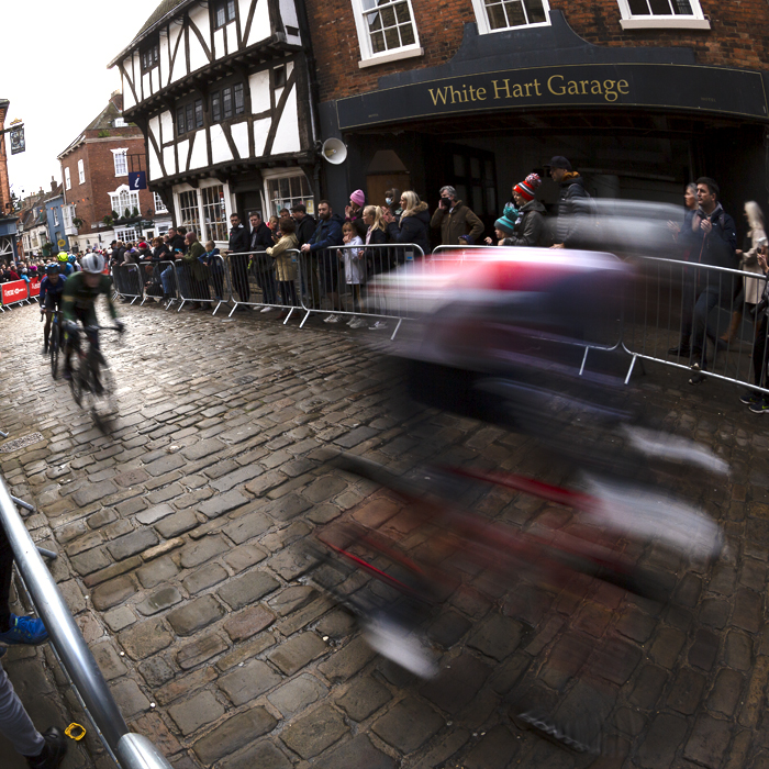 British National Road Championships 2021 - Men’s Road Race - Riders speed past in a blur as fans line Bailgate near medieval buildings