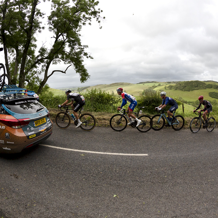 British National Road Championships 2022 - Men’s Road Race -  Riders pass by a panoramic view with a Ribble team car leading the way