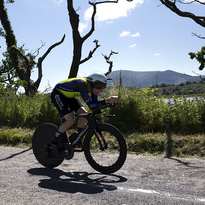 British National Road Championships 2022 - Men’s Time Trial -  Mark Stewart of Bolton Equities Black Spoke Pro Cycling rides past distant Scottish scenery