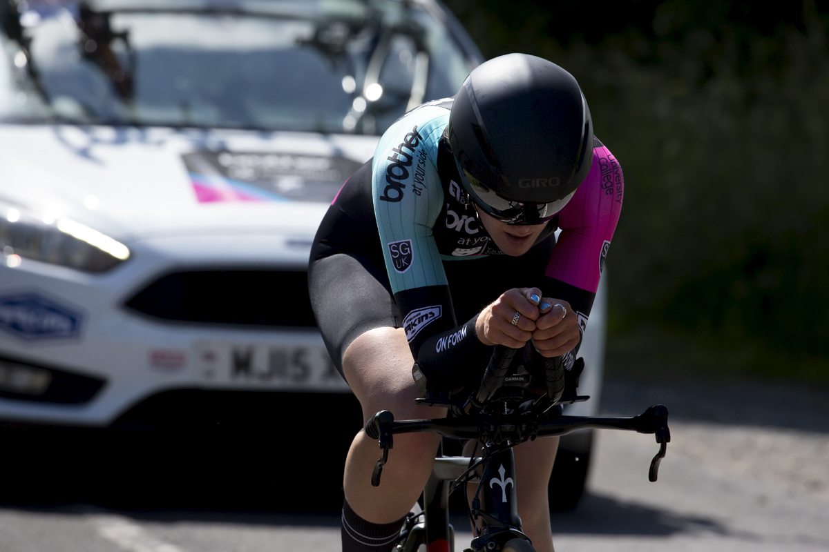 British National Road Championships 2022 - Women’s U23 Time Trial - Daisy Barnes of Brother UK-Orientation Marketing seen from the front followed by her support vehicle