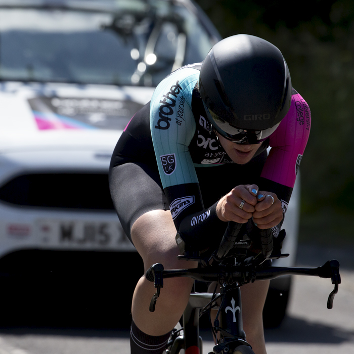 British National Road Championships 2022 - Women’s U23 Time Trial - Daisy Barnes of Brother UK-Orientation Marketing seen from the front followed by her support vehicle